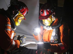 Glencore Sudbury Integrated Nickel Operations mine rescue team members captain Andrew Jorgensen and Rock Carriere document conditions, location and airflow throughout the competition during the district mine rescue competition in Sudbury, Ont. on Thursday May 11, 2017. Gino Donato/Sudbury Star/Postmedia Network