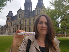 Lea L'Hoir holds a "Unicorn Milk" vape fluid container is this undated handout image from Fredericton. A New Brunswick mother says her nine-year-old daughter was hospitalized after consuming e-cigarette fluids from a brightly labelled "Unicorn Milk'' bottle. THE CANADIAN PRESS/HO