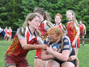 The Bayside She Devils (in red), shown during a muddy semi-final win over Clinton St. Anne's, won the gold medal at the OFSAA AA girls rugby championships Wednesday in Oshawa. (Catherine Frost for The Intelligencer)
