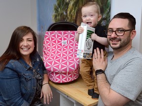 Sabrina and Michael Maulucci and son Jasper with some of the covers the couple makes for baby seats and strollers which will be featured at the Modern Mom Show. (MORRIS LAMONT/THE LONDON FREE PRESS)