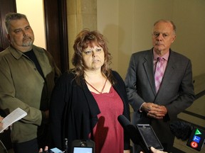 Lila Fifi (centre) joins her brother Martin Korsch (left) and Liberal MLA Jon Gerrard (right) at the Manitoba Legislature May 31, 2017 to call for an inquiry into her husband David's death in November 2008 after he worked at a mine in northern Manitoba. (JOYANNE PURSAGA/Winnipeg Sun/Postmedia Network)