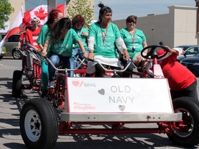 Members of the Old Navy team gear up for their ride on the Big Bike at the RioCan Centre for the Heart and Stroke Foundation fundraiser on Tuesday.( Amanda Norris/For The Whig-Standard)