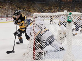 Penguins’ Jake Guentzel gets the puck past Predators’ goalie Pekka Rinne during the first period in Pittsburgh last night. (Getty Images)