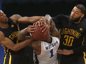 Halifax Hurricanes Tyrone Watson gets shut down by London Lightning Marcus Capers, left, and Royce White during their game on  May 30. (Mike Dembeck, Special to The Free Press)