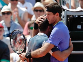 Spain's Nicolas Almagro is comforted by Argentina's Juan Martin Del Potro as he's forced to withdraw due to an injury during a match at the Roland Garros French Open on June 1, 2017 in Paris. (AFP PHOTO)