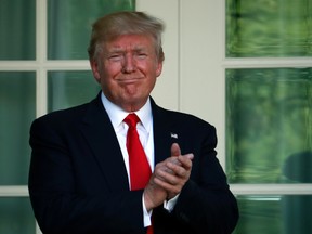 U.S. President Donald Trump applauds after speaking about the U.S. role in the Paris climate change accord in the Rose Garden at the White House in Washington on Thursday, June 1, 2017. (AP Photo/Pablo Martinez Monsivais)