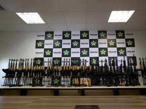 Police show confiscated automatic rifles during a press conference in Rio de Janeiro, Brazil, Thursday, June 1, 2017. Brazilian police say they confiscated 60 automatic rifles found in a cargo shipment at Rio de Janeiro's international airport. The weapons were found Thursday in a container with pool heaters in a shipment from Miami, and four people have been arrested. (AP Photo/Silvia Izquierdo)
