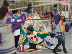 Olivia Santa Rosa (right) with the Roger's Angels team scores on the Fifth Element team during NorQuest College's annual road hockey tournament in Edmonton, Alberta on Friday, November 4, 2016. Ian Kucerak / Postmedia