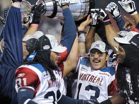 Montreal Alouettes quarterback Anthony Calvillo, flanked by teammates Mark Estelle (left) and Jerald Brown celebrate their 2010 Grey Cup victory over the Saskatchewan Roughriders at Commonwealth Stadium in Edmonton November 28, 2010.