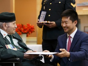 Kangjun Lee, Consul General of the Republic of Korea, presents Samuel Frischknet (left) with an Ambassador For Peace Medal at the Kipnes Centre for Veterans in Edmonton on Thursday, June 1, 2017. Ian Kucerak / Postmedia