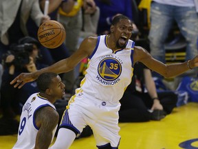 Warriors forward Kevin Durant (35) reacts after dunking against the Cavaliers next to forward Andre Iguodala during the first half of Game 1 of the NBA Finals in Oakland, Calif., on Thursday, June 1, 2017. (AP Photo/Ben Margot)
