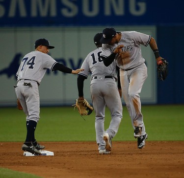 New York Yankees Ronald Torreyes SS (74), Didi Gregorius SS (18) and Aaron Hicks (R) celebrate the 12-2 win in Toronto, Ont. on Thursday June 1, 2017. Jack Boland/Toronto Sun/Postmedia Network