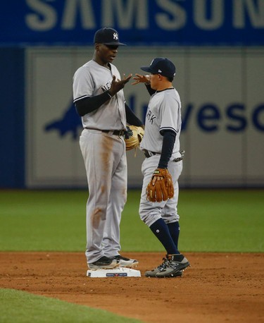 New York Yankees Ronald Torreyes SS (74- right) celebrates magic fingers with Chris Carter 1B (48) after their 12-2 win   in Toronto, Ont. on Thursday June 1, 2017. Jack Boland/Toronto Sun/Postmedia Network