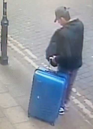 This is a handout photo taken on Monday, May 22, 2017 from CCTV and issued on Monday, May 29, 2017 by Greater Manchester Police of Salman Abedi in an unknown location of the city centre in Manchester, England. The police released an image of the bomber carrying a distinctive blue suitcase and an image of a replica of the case as they appealed for information about his final days. (Greater Manchester Police via AP) ORG XMIT: LON807
