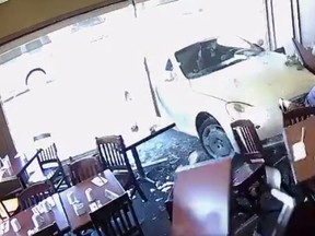 On Tuesday, a car crashed through the window at Silk's Country Kitchen in Niagara-on-the-Lake, Ont., pinning two men against the wall. The men weren't seriously hurt. (Blair Robertson/Facebook)