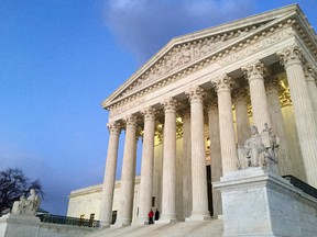 In this Feb. 13, 2016, file photo, people stand on the steps of the Supreme Court at sunset in Washington. The Trump administration made a plea to the Supreme Court on June 1, 2017, to let travel ban take effect (AP Photo/Jon Elswick, file)