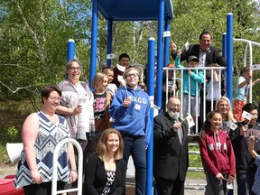 Members of the Onaping Falls Recreation Committee, Levack Public School students, and local politicians gathered around a play structure at the Onaping Falls Community Centre to celebrate a funding announcement by the Government of Canada in Onaping, Ont. on Friday June 2, 2017. John Lappa/Sudbury Star/Postmedia Network