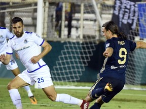 FC Edmonton defender Adam Straith, left, attempts to block a shot from North Carolina FC striker Matthew Fondy in North American Soccer League play on Saturday, April 15 at WakeMed Soccer Park in Cary, North Carolina.