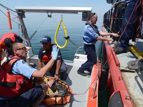 In this file photo from Saturday May 28, 2016, Port Colborne Marine Auxiliary Rescue (POCOMAR) unit crew members work with Canadian Coast Guard members from the Private Robertson V.C. during an annual large-scale search and rescue exercise on Lake Erie off of Port Colborne. Dave Johnson/Welland Tribune/Postmedia Network