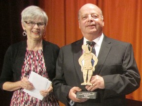Crime fiction author Rick Blechta, right, was presented with this year's Arthur Ellis Award for best novella by Linda Wiken at a ceremony Nov. 27. Blechta will be one of the guests of honour at the Limestone Genre Expo being held at St. Lawrence College Saturday and Sunday. (Submitted photo)