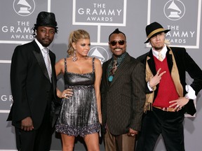 In this Feb. 11, 2007 file photo, The Black Eyed Peas, from left, will.I.am, Fergie, apl.de.ap and Taboo arrive for the 49th Annual Grammy Awards in Los Angeles. (AP Photo/Matt Sayles, File)