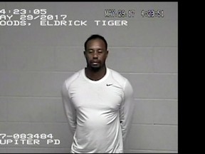 In this May 29, 2017, image made from a surveillance video provided by the Jupiter Police Department, Tiger Woods stands in Palm Beach County jail following his DUI arrest in Palm Beach County, Fla. (Jupiter Police Department via AP)
