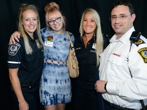 Jennifer Samways, second left, is flanked by the paramedics who saved her life, Maggie Timmers, left, Tristen Caldwell and Adam Bennett at Friday?s Cardiac Arrest Survivor Day at Fanshawe College. (MORRIS LAMONT, The London Free Press)