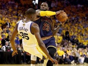 Warriors’ Kevin Durant draws a charging foul on Cavaliers star LeBron James in Game 1 of the NBA Finals on Thursday, June 1, 2017. Durant had his way against the Cavs, scoring a game-high 38 points. (Ezra Shaw/Getty Images)