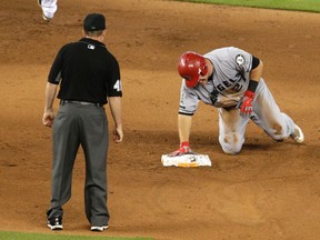 Mike Trout winces as he favours his injured left thumb following a slide into second last Sunday. He underwent surgery on it on Wednesday. (Lynne  Sladky, AP)