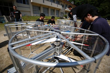 Members of Cartivator work on the test model of a flying car on a former school ground in Toyota, central Japan, Saturday, June 3, 2017. (AP Photo/Koji Ueda)