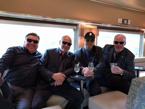 From left to right, Kenton Tasker (Crystal Head director of sales, Canada), Davey Brown, Danny Aykroyd and retired Kingston copper Mike Attwood on VIA Train to Ottawa yesterday. (SUPPLIED)