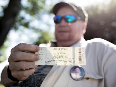 Mark Elliott shows a concert ticket from the last Gregg Allman concert he attended, Saturday, June 3, 2017, in Macon, Ga. (AP Photo/Branden Camp)