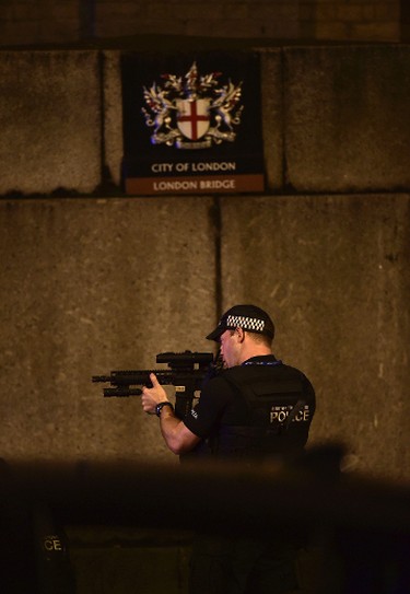 An armed Police officer looks through his weapon on London Bridge in London, Saturday, June 3, 2017.  British police said they were dealing with "incidents" on London Bridge and nearby Borough Market in the heart of the British capital Saturday, as witnesses reported a vehicle veering off the road and hitting several pedestrians. (Dominic Lipinski/PA via AP)