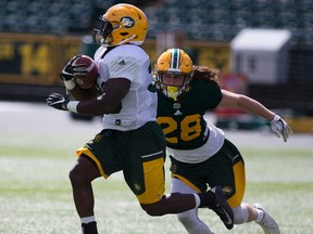 Jordan Hoover chases down Johnny Augustin during the Edmonton Eskimos intra-squad game on Friday June 2, 2017, in Edmonton.