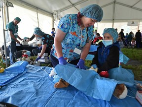 Samual Joyce, 10, with Dr. Cheryl Lewis in the surgrey room at the Teddy Bear Hospital as children from the Stollery Children's Hospital attended Dream Night at the Zoo, a special night visit at the Valley Zoo in Edmonton, June 2, 2017. Ed Kaiser/Postmedia