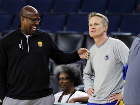 Golden State Warriors head coach Steve Kerr, right, talks with interim head coach Mike Brown Wednesday, May 31, 2017, in Oakland, Calif. (AP Photo/Marcio Jose Sanchez)