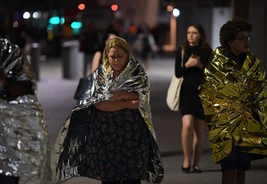 Members of the public, wrapped in emergency blankets leave the scene of a terror attack on London Bridge in central London on June 3, 2017.  (CHRIS J. RATCLIFFE/AFP/Getty Images)