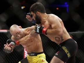 Marlon Moraes, left, and Raphael Assuncao fight during their UFC 212 bantamweight bout in Rio de Janeiro, Brazil, Saturday, June 3, 2017. (AP Photo/Leo Correa)