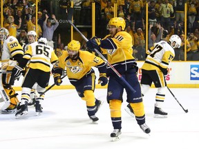 Viktor Arvidsson (right) of the Nashville Predators celebrates a second-period goal against the Pittsburgh Penguins in Game 3 of the Stanley Cup final at the Bridgestone Arena in Nashville, Tenn. last night. The Preds won 5-1. (Getty Images)