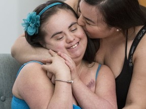 Yasmin Munoz hugs her sister, Francie (CRAIG ROBERTSON, Toronto Sun)