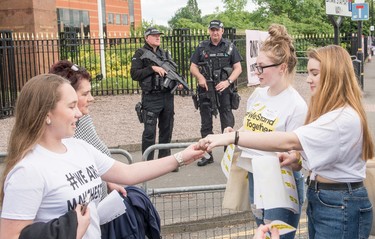 Members of the public pose are given 'We Stand Together' stickers as they arrive ahead of the One Love Manchester Benefit Concert on June 4, 2017 in Manchester, England. (Richard Stonehouse/Getty Images)