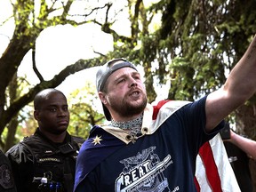 In this April 29, 2017, file photo provided by John Rudoff, Jeremy Joseph Christian, right, talks during a Patriot Prayer organized by a pro-Trump group in Portland, Ore. (John Rudoff via AP, File)