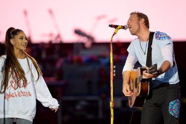 In this handout provided by 'One Love Manchester' benefit concert (L) Ariana Grande and Chris Martin perform on stage on June 4, 2017 in Manchester, England. (Getty Images/Dave Hogan for One Love Manchester)