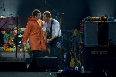 In this handout provided by 'One Love Manchester' benefit concert (L) Liam Gallagher and Chris Martin perform on stage on June 4, 2017 in Manchester, England. (Getty Images/Dave Hogan for One Love Manchester)