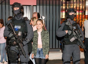 Armed Counter Terrorism Officers pose with concertgoers after the One Love Manchester Benefit Concert on June 4, 2017 in Manchester, England.  (Photo by Richard Stonehouse/Getty Images)