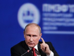 In this Friday, June 2, 2017, file photo, Russian President Vladimir Putin gestures as he speaks at the St. Petersburg International Economic Forum in St. Petersburg, Russia. Putin is dismissing as "a load of nonsense" the idea that Russia has damaging information on President Donald Trump and denies having any relationship with him, said Putin in an interview with NBC's "Sunday Night with Megyn Kelly." (AP Photo/Dmitry Lovetsky, File)