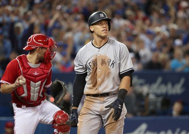 TORONTO, ON - JUNE 4: Aaron Judge #99 of the New York Yankees reacts after striking out in the ninth inning during MLB game action as Luke Maile #22 of the Toronto Blue Jays throws the ball down to third base at Rogers Centre on June 4, 2017 in Toronto, Canada. (Photo by Tom Szczerbowski/Getty Images)