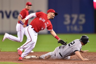 New York Yankees' Chase Headley (right) steals second base under the tag by Toronto Blue Jays second baseman Devon Travis during third inning American League baseball action in Toronto, Sunday, June 4, 2017. THE CANADIAN PRESS/Frank Gunn ORG XMIT: FNG502