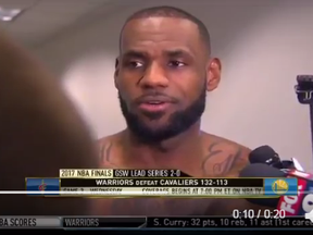 Lebron James talks with reporters post-game.