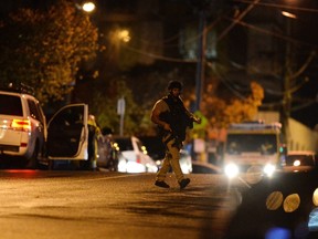 An armed police officer walks at the scene in the Melbourne bayside suburb of Brighton on June 5, 2017, after a woman was held against her will in an apartment block in an incident authorities had yet to determine whether was terrorism-related. Australian police on June 5 shot dead a man who took the woman hostage in a Melbourne apartment, after the body of another man was found in the building's lobby. The woman escaped safely but three officers were injured as police stormed the building. / AFP PHOTO / Mal FaircloughMAL FAIRCLOUGH/AFP/Getty Images